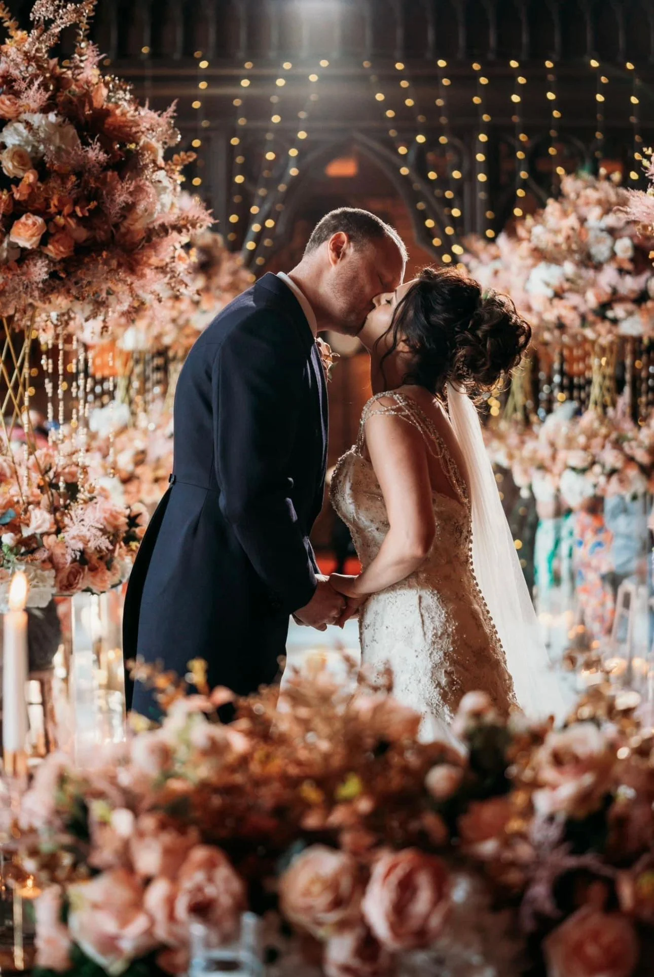 Bride & Groom surrounded by Rose gold flower arrangement